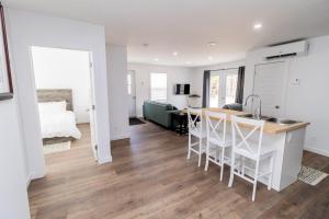 a kitchen and living room with a sink and a table at The Apartment in Deer Lake