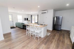 a kitchen and living room with a table and a refrigerator at The Apartment in Deer Lake +11 photos