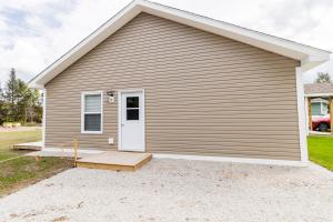 a house with a white door and a porch at The Apartment in Deer Lake