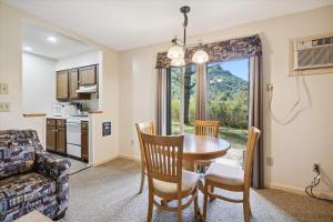 a kitchen and dining room with a table and chairs at Cedarbrook Deluxe Two Bedroom Suite, With heated pool 10102 in Killington