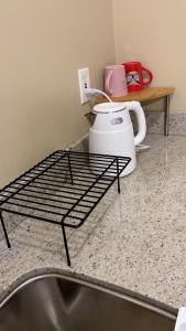 a iron bed in a kitchen with a sink at Hudson House in Vancouver