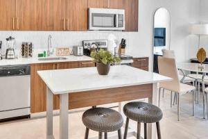 a kitchen with a table and two stools at Wonderful Unit In Downtown Miami With Free Parking in Miami