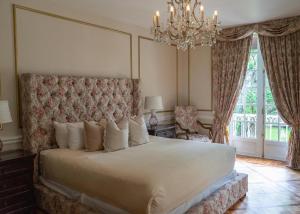 a bedroom with a large bed and a chandelier at Mansión Papilio in Mexico City +89 photos