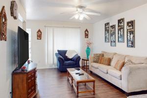 a living room with a couch and a tv at Brickside Beauty in Killeen