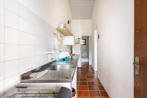 a kitchen with a sink and a counter top at Ilhabela Chalés in Ilhabela