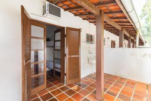a bathroom with an open door in a house at Ilhabela Chalés in Ilhabela