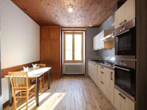 a kitchen with a table and a dining room at Gîte Le Chambon-sur-Lignon, 9 pièces, 15 personnes - FR-1-582-21 in Le Chambon-sur-Lignon