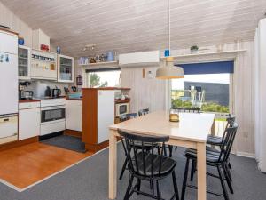 a kitchen with a table and chairs in a room at Two-Bedroom Holiday home in Lemvig 1 in Lemvig