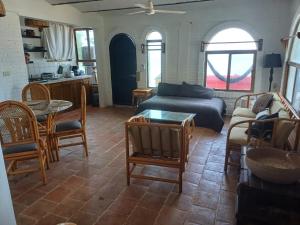 a living room with a couch and a table at Loft Playa Los Venados #2 in Lo de Marcos