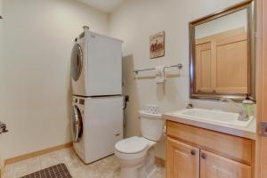 a bathroom with a toilet and a sink and a refrigerator at Lovely Big Sky Getaway Near Skiing and Golf! in Big Sky