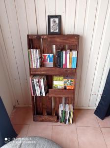 a book shelf filled with books in a room at Suite Loreto in Caldera