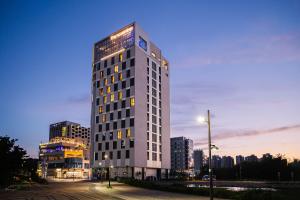 a tall building in a city at night at OCEAN PARK 9 in Incheon