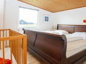 a bedroom with a large bed and a window at Three-Bedroom Holiday home in Harboøre 12 in Harboør