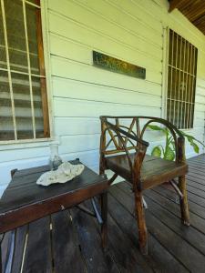 a chair and a bench on a porch at LOTO'S House in West End