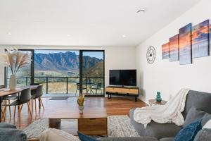 a living room with a view of the mountains at Style & Tranquillity - 4 Bedroom House in Queenstown