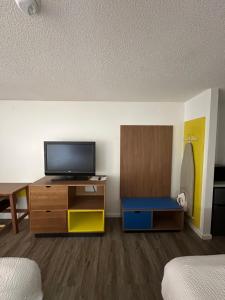 a room with a tv on a dresser at Days Inn by Wyndham Decatur Priceville I-65 Exit 334 in Decatur