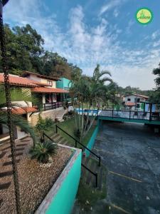 a view from the balcony of a resort with a bridge at Pousada Arthemis in Garopaba