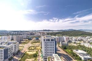 an aerial view of a city with tall buildings at Skytop Hotel Incheon Airport in Incheon