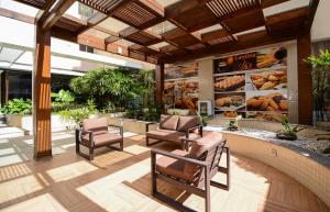 a restaurant with two chairs and a swimming pool at ótima localizacao e perto de tudo in São José