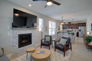 a living room with a fireplace and a kitchen at Sand By Me in Ocean Shores