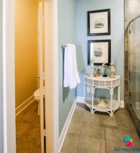 a bathroom with a shower and a toilet and a towel at Beachfront Oasis At Tybee Island in Tybee Island