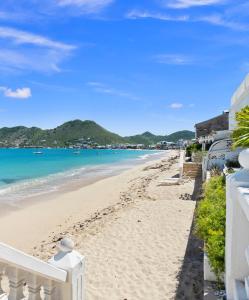 a view of the beach from the balcony of a house at Beyond Seas Studio in Saint Martin
