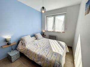 Schlafzimmer mit einem Bett und einem Fenster in der Unterkunft Maison Jullouville, 3 pièces, 6 personnes - FR-1-361-464 in Jullouville-les-Pins