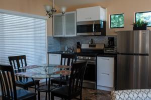 a kitchen with a table and chairs and a refrigerator at Large Luxury Studio with View in Santa Monica in Santa Monica