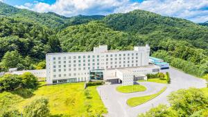 an overhead view of a building with mountains in the background at KAMENOI HOTEL Aomori Makado in Noheji