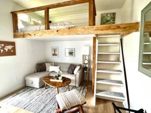 a living room with a loft bed and a couch at Hale ‘Aina (Country Cottage) in Keaau