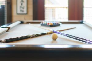 a pool table with two cue sticks and a ball at Huny Bear Lodge in Pigeon Forge