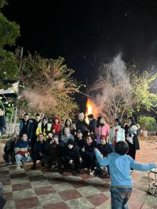 a group of people posing in front of a fire at Cao nguyên in Mộc Châu