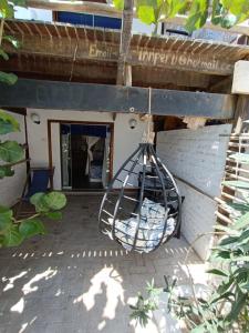 a metal bird cage hanging from the side of a building at Mancora Apartments in Máncora