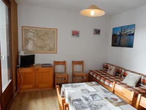 a living room with a couch and a table at Appartement La Plagne Montalbert , 2 pièces, 5 personnes - FR-1-181-2723 in Aime-La Plagne