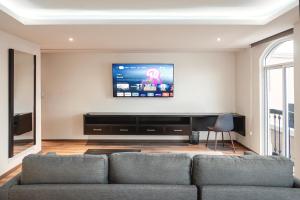 a living room with a couch and a flat screen tv at Sendero Hotel in Actopan