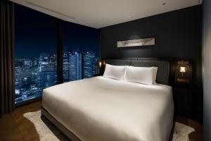 Postel nebo postele na pokoji v ubytování BELLUSTAR TOKYO, A Pan Pacific Hotel