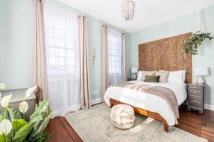 a bedroom with a bed and a large window at Charming Secluded Courtyard - 1 BLOCK TO KING in Charleston