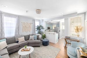 a living room with a couch and a table at Hidden Outdoor Oasis - 1 BLOCK TO KING in Charleston +26 photos
