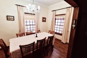a dining room with a white table and chairs at Historic Schoolhouse Rockley in Rockley