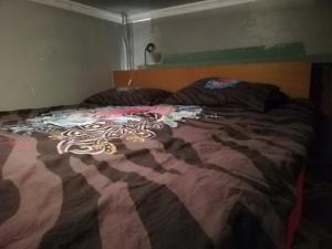 a bed with a colorful blanket on top of it at Lockable room center in Antwerp