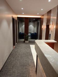 a hallway of a hotel lobby with a reception desk at Buddha Stays in Varanasi