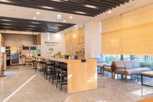 a lobby with a kitchen and a bar with chairs at Ocean Soleview Hotel in Incheon