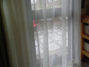 a window with a white curtain on it at Fynbos Single Stay in Langebaan