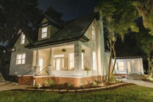 a house with a black roof at night at Newly Reno'd Historic Mansion 1 Mile to UF & DT in Gainesville