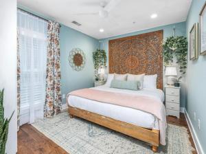 a bedroom with a bed with a large headboard at Secluded Courtyard & Parking - 2 Blocks to King in Charleston