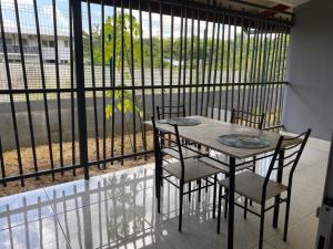 d'une table et de chaises sur un balcon avec une clôture. dans l'établissement ST-Laurent Haut de Balate Confort, à Saint-Laurent du Maroni