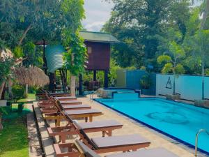una piscina con tumbonas y un complejo en Yala River Front Hotel & Restaurant en Tissamaharama