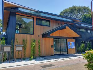 a house with a large glass door on a street at TOKIWA M-GARDEN in Mito