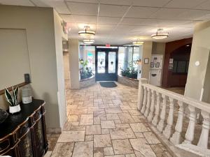 a lobby with a staircase and a blue door at Pirates Cove 4th Floor Balcony Remodeled Condo in Daytona Beach
