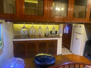 a kitchen with wooden cabinets and blue glass vases at Country village San Bernardino in San Bernardino